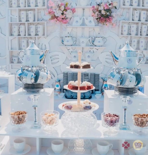 An elaborate pale blue and white display with teapots and glassware