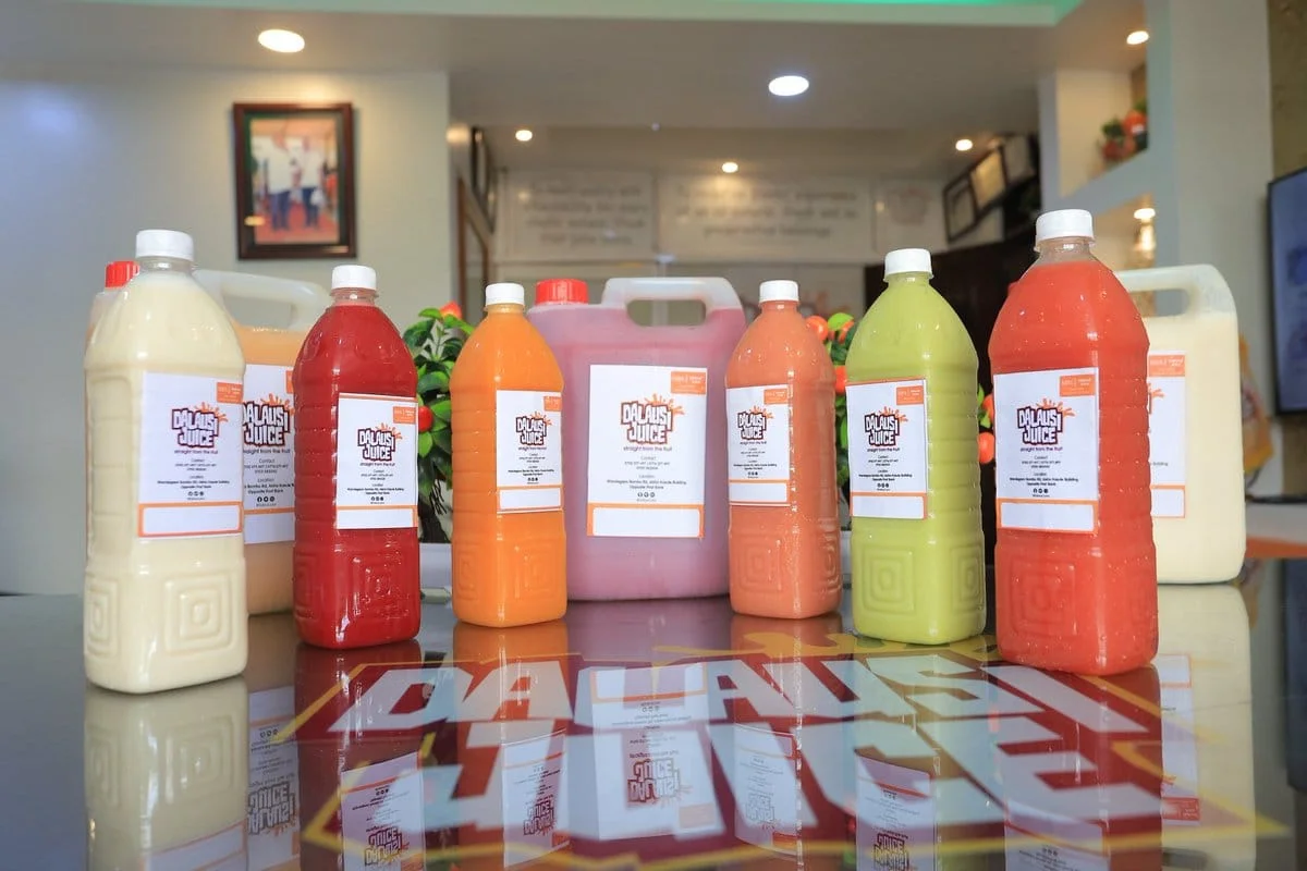Dalausi’s real juice bottles and larger containers, filled with colourful fresh juices at the shop
